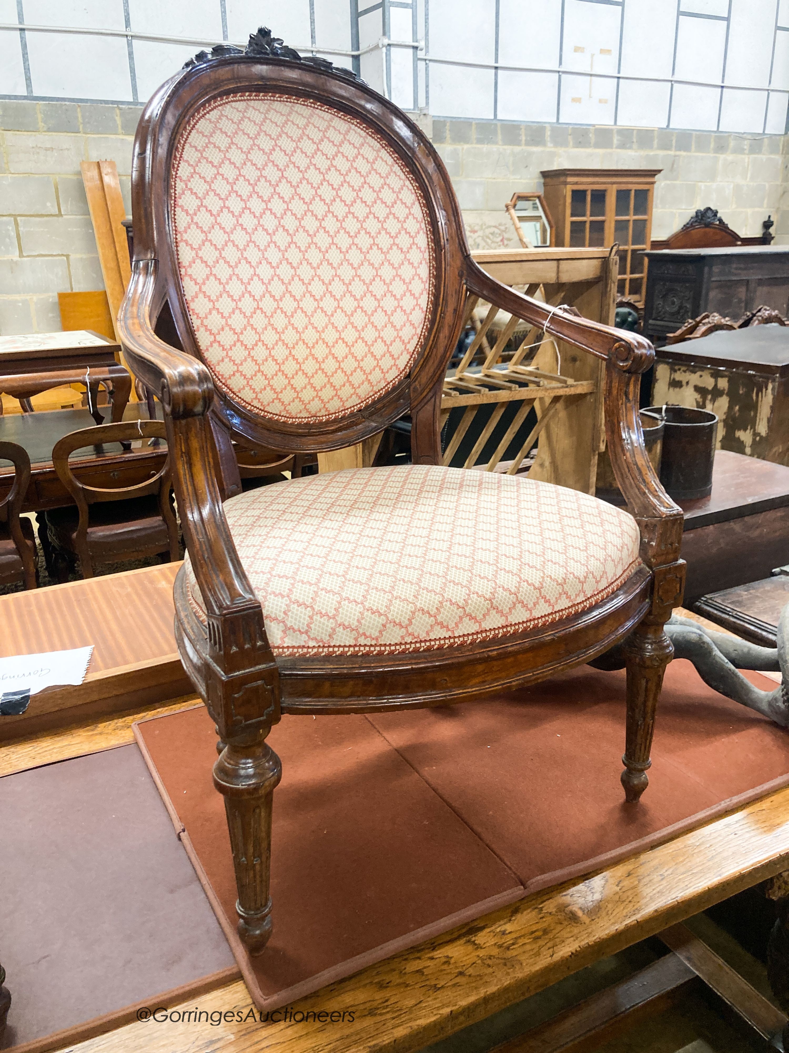 A pair of 19th century French walnut upholstered elbow chairs, W.62cm D.50cm H.102cm